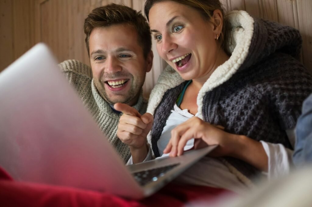 Happy european family making shopping in internet using laptop.